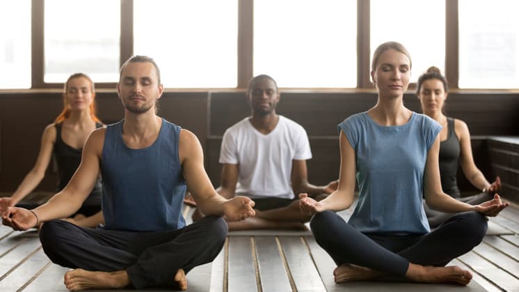 Person practicing mindfulness techniques to stop porn urges, showing calm environment with meditation elements